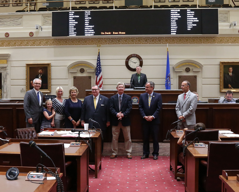 Sen. Darcy Jech, R- Kingfisher (far left) joins SEOSU Coach Mike Metheny (center), SEOSU President, Sean Burrage (2nd from right), SEOSU Athletic Director Keith Baxter (far right) and former SEOSU president and Chancellor of Higher Education Glen D. Johnson (left of Coach Metheny) on the Senate floor at the State Capitol on Tuesday, May 9. Also pictured are Metheny’s wife Pat, daughter Mishael and granddaughter Raini.